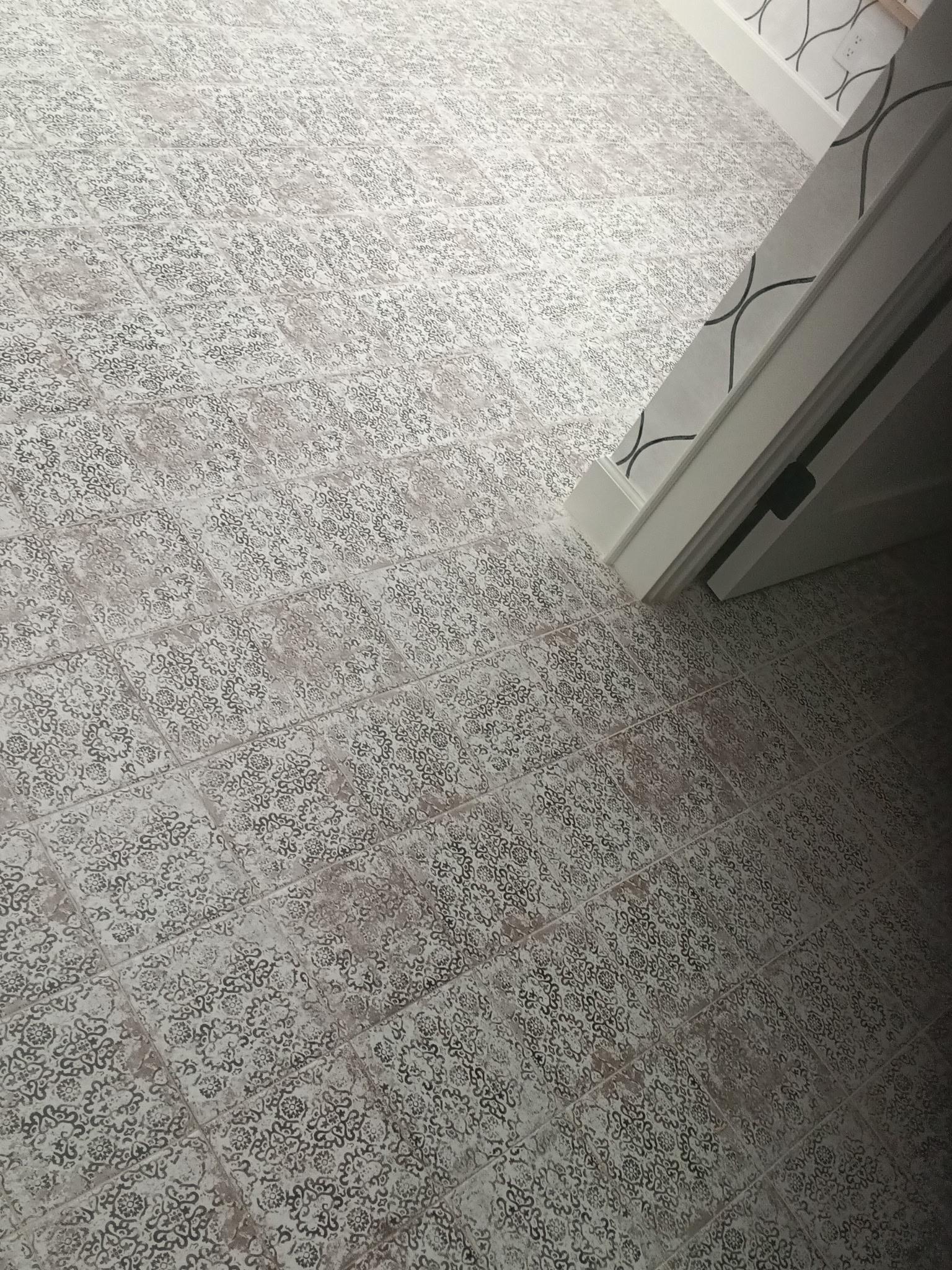 Patterned tile surface cleaned and restored by DirtyGrout